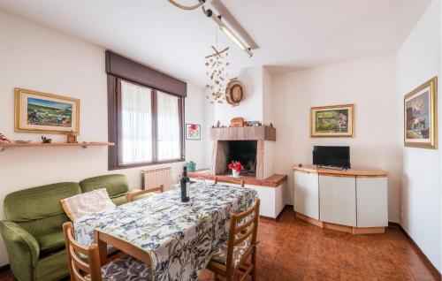 a dining room with a table and a fireplace at Casa Lucia in Villadose