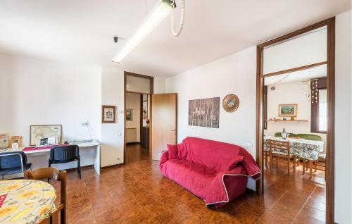 a living room with a red couch and a table at Casa Lucia in Villadose