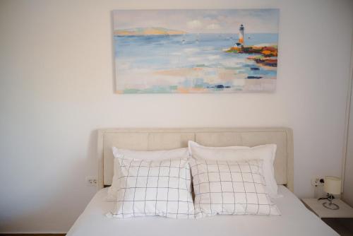 a bedroom with a bed with a painting on the wall at Apartmani Natalija 4 Stars in Mrljane