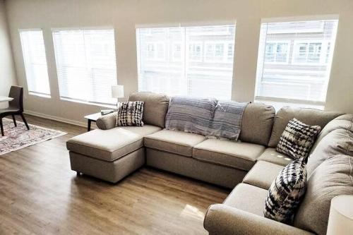a living room with a couch and a table at The Meadowlark at Coventry Rows in Omaha
