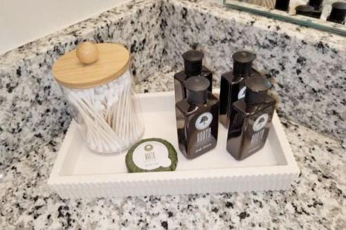 a shelf with three bottles of soap on a counter at The Meadowlark at Coventry Rows in Omaha