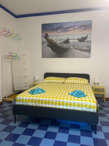 a bedroom with a bed and a painting on the wall at Naxos Beach House in Giardini Naxos