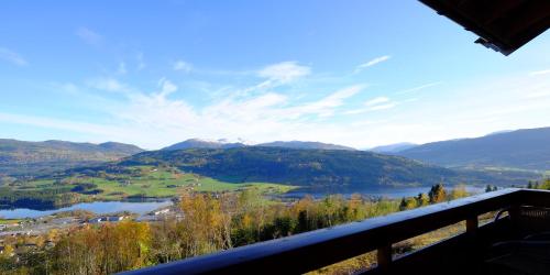 a view of a lake and mountains from a balcony at Voss Resort self-service apartments in Skulestadmo