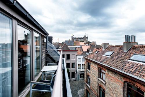 a view of the city from the balcony of a building at Hotel Harmony in Ghent
