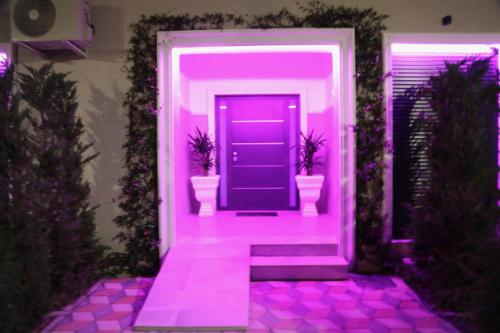 a purple hallway with a purple door with two toilets at Anchor Luxury Rooms in Vlorë