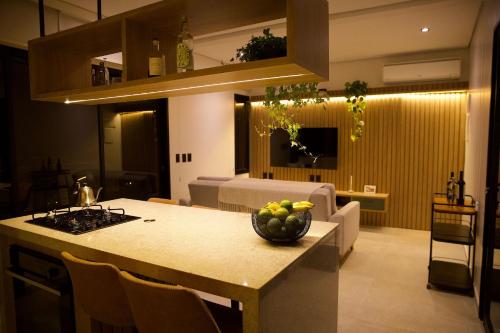 a kitchen with a table with a bowl of fruit on it at Casa Nengueta - Lapinha da Serra in Santana do Riacho