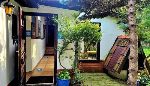an open door of a house with a tree at Park Apartment in Kraków