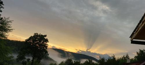a sunset with a view of a mountain at Odaia Bunicilor in Feldru