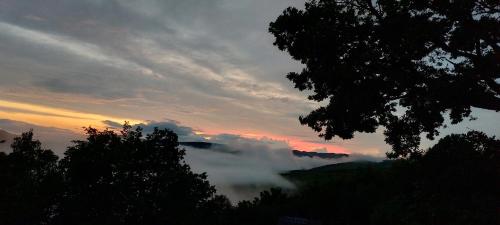 a view of a mountain with clouds in the sky at Odaia Bunicilor in Feldru