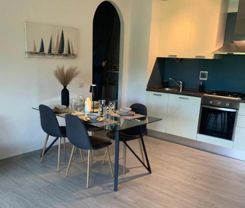 a dining room with a table and chairs in a kitchen at Bilocale nuovo - Basiglio Humanitas in Basiglio