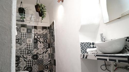 a bathroom with a sink and a shower at Luxy Gargano Suite in San Giovanni Rotondo