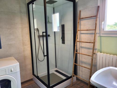 a shower with a glass door in a bathroom at Maison de bord de mer, les Fleurs in Créances