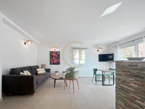 un salon avec un canapé et une table dans l'établissement Ile Rousse T2 proche centre-ville, à LʼÎle-Rousse