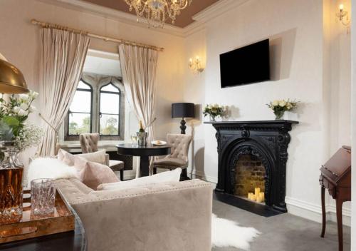a living room with a couch and a fireplace at Kilkea Castle in Kilkea