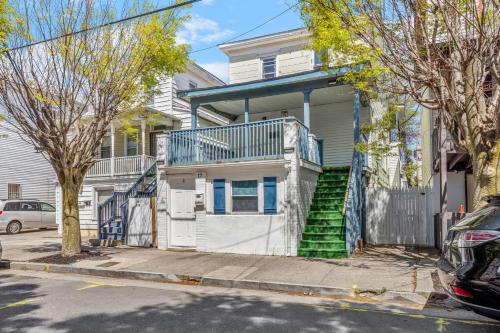 a white house with a balcony on a street at 9 Bedroom, 14 Beds House Great for Big Groups Near Boardwalk, Tropicana in Atlantic City