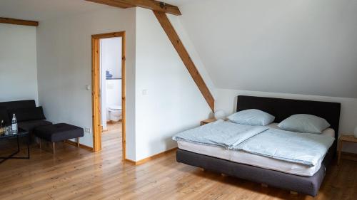 a bedroom with a bed and a table and a chair at Hotel Rhodter Adler in Rhodt unter Rietburg