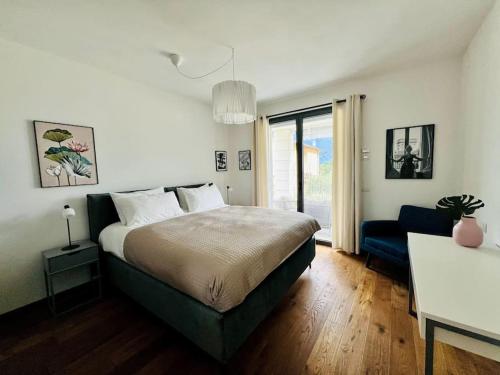 a bedroom with a bed and a blue couch at NaLia Apartment in Ossuccio in Ossuccio