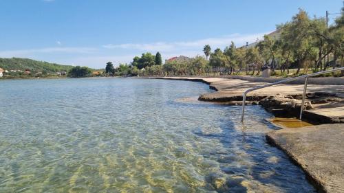 a large body of water with trees in the background at Apartmani Natalija 4 Stars in Mrljane