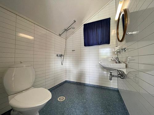 a bathroom with a toilet and a sink at Selje Camping - Hytte Nr 4 in Selje