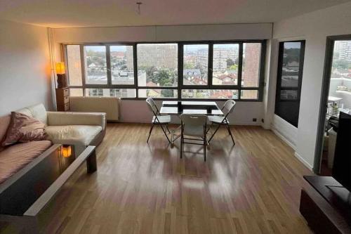 un salon avec un canapé, une table et des chaises dans l'établissement -N7 Appartement- 6 min to metro, à Villejuif