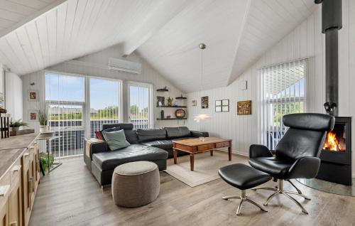 a living room with a couch and a table at Nice Home In Hemmet With Wifi in Hemmet
