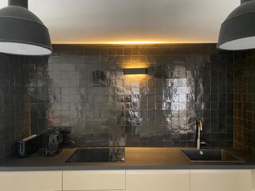 une cuisine avec un évier et un plan de travail dans l'établissement Au Vieux Bassin, à Honfleur