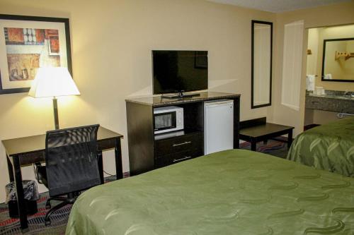 a hotel room with a bed and a television at Motel 6 Knoxville, Tn - East in Knoxville