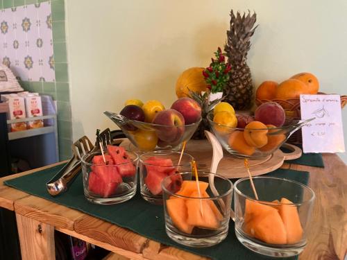 a bunch of bowls of fruit on a table at Il Casale di David in Pontedera