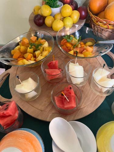 a table topped with bowls of fruit and bowls of cheese at Il Casale di David in Pontedera