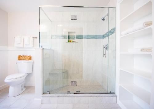 a shower with a glass door in a bathroom at Cleftstone Inn in Bar Harbor