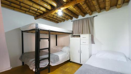 Ένα ή περισσότερα κρεβάτια σε δωμάτιο στο Finca Hotel Buenos Aires
