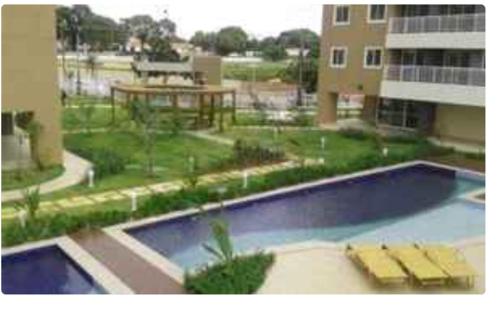 a large swimming pool in front of a building at Quarto em condomínio no bairro Fátima in Fortaleza