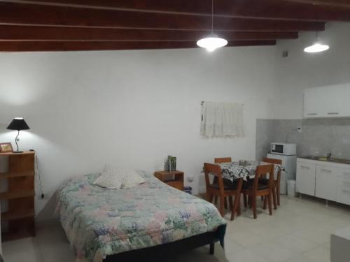 a bedroom with a bed and a table and chairs at Departamento Lucia in Trelew