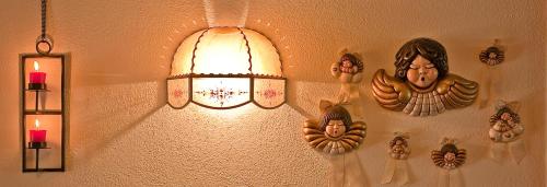 a light on a wall with some decorations on it at Hotel Bad Winkel in Campo Tures