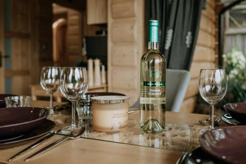 a bottle of wine sitting on a table with glasses at Zacisze Galicove in Zakopane