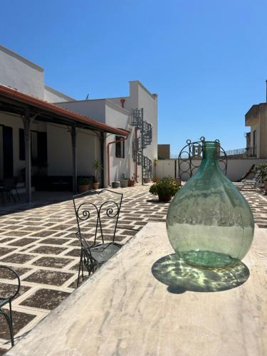 a glass vase sitting on a table on a patio at B&B Palazzo Giordano Luxury Rooms in Squinzano