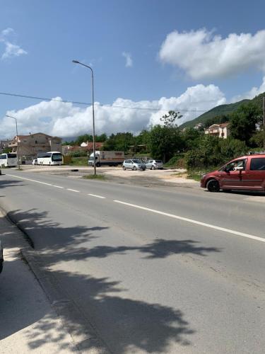 a street with cars parked on the side of a road at Apartment Sova in Tivat