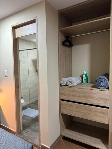 a bathroom with a walk in shower and a mirror at Hostelfc Usaquen in Bogotá