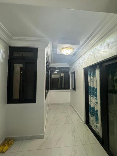 a hallway with white walls and a ceiling at App Résidence Amadou et Coumba in Dakar