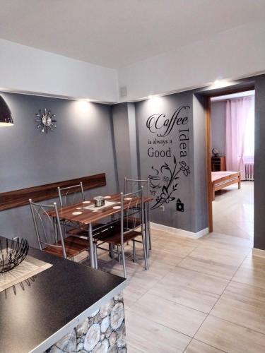 a dining room with a table and chairs at Apartament Dolek in Szczawnica