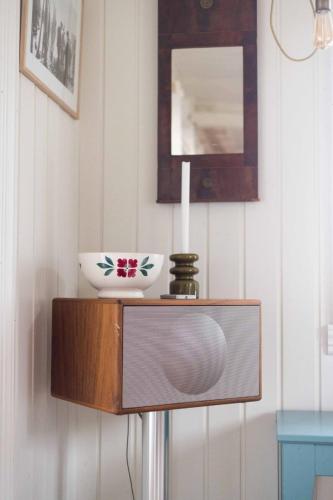a television with a bowl on top of it at Historic House, 1880 - Stunning Panoramic Views in Sørvågen