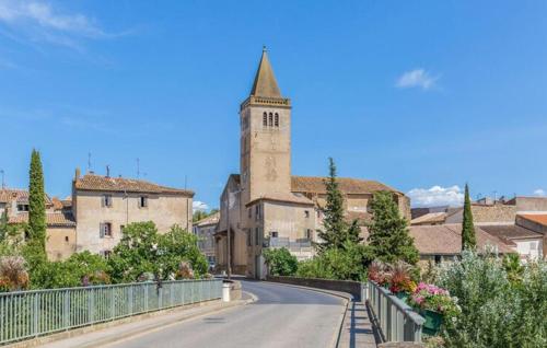 a road in a town with a tower and a church at Beautiful Home In Saint-Laurent-De-La-Cabrerisse in Saint-Laurent-de-la-Cabrerisse