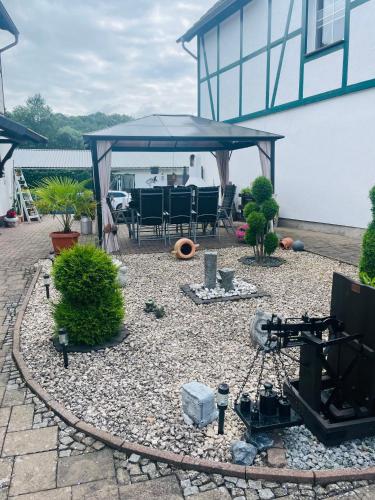 a patio with a tent and a table and chairs at Holla die Waldfee in Königerode