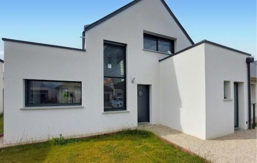 a white house with a black roof at Maison Moderne Proche Plage in Saint-Coulomb
