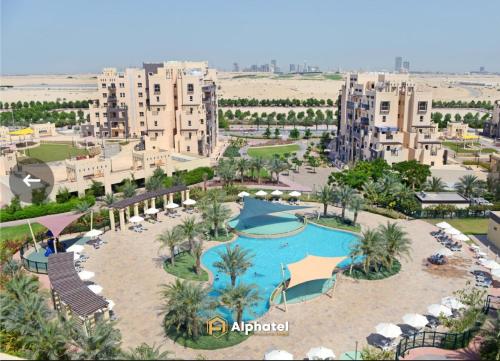 an aerial view of a resort with a pool at 2-Bedroom Holiday Home in Remraam Community - Dubai - by Alphatel Vacations in Dubai
