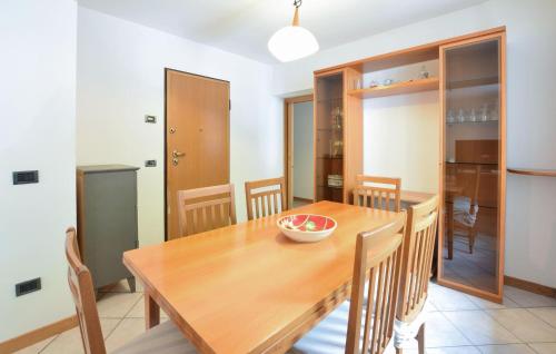 a kitchen and dining room with a wooden table and chairs at Nice Apartment In Bagolino, Fraz, Ponte in Ponte Caffaro