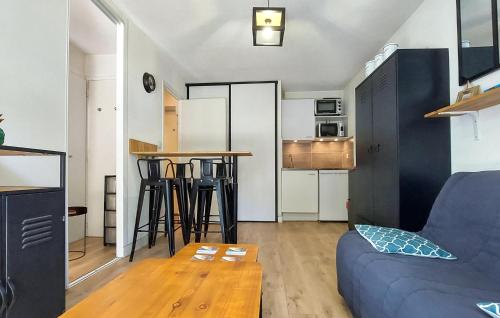 a living room with a couch and a table at 1 Bedroom Amazing Apartment In Carnac in Carnac