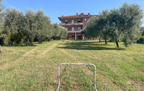 a soccer goal in a field with trees and a building at Lovely Apartment In Tuoro Sul Trasimeno With Wifi in Tuoro sul Trasimeno