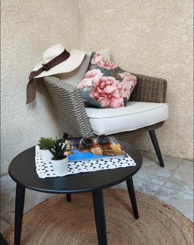 a coffee table in front of a chair with a table sidx sidx sidx at La cave à Papé in Peyriac-de-Mer