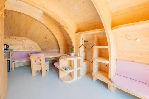 a wooden cabin with a bed and bunk beds at Les chaumières de Brameix in Neuvic